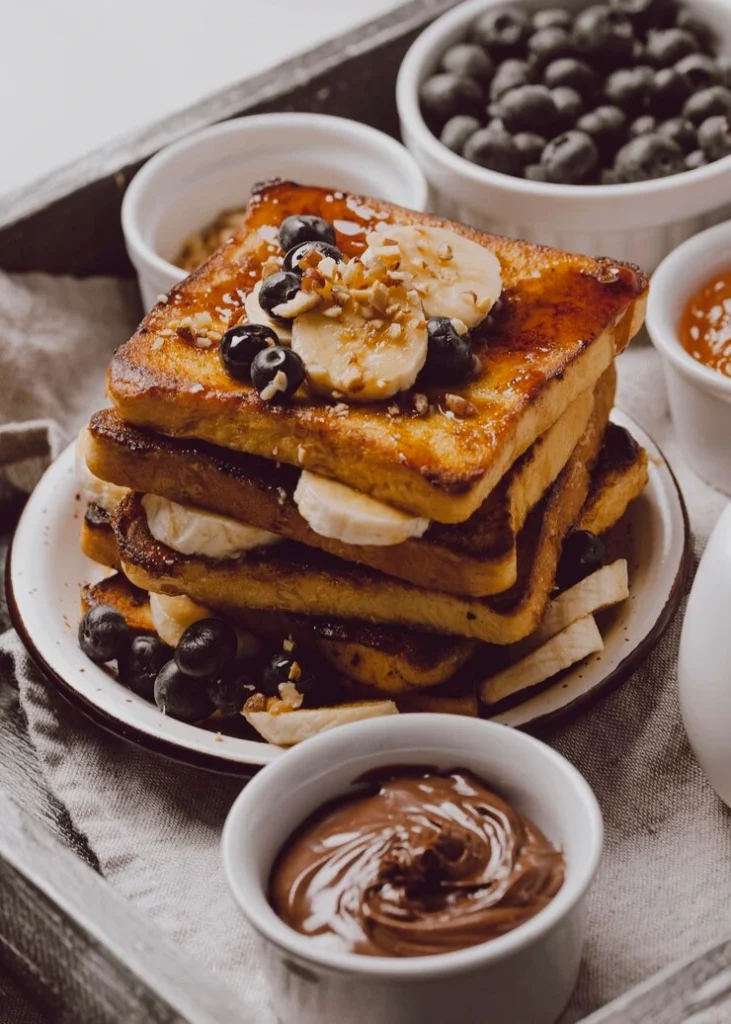McCormick French Toast
Fluffy French toast slices on a white plate, topped with fresh berries and a drizzle of maple syrup, seasoned with McCormick vanilla and cinnamon.