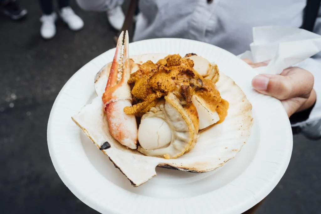 Close-up of a luxurious Crab Brûlée with a golden caramelized sugar top and delicate crab meat inside, garnished with herbs
