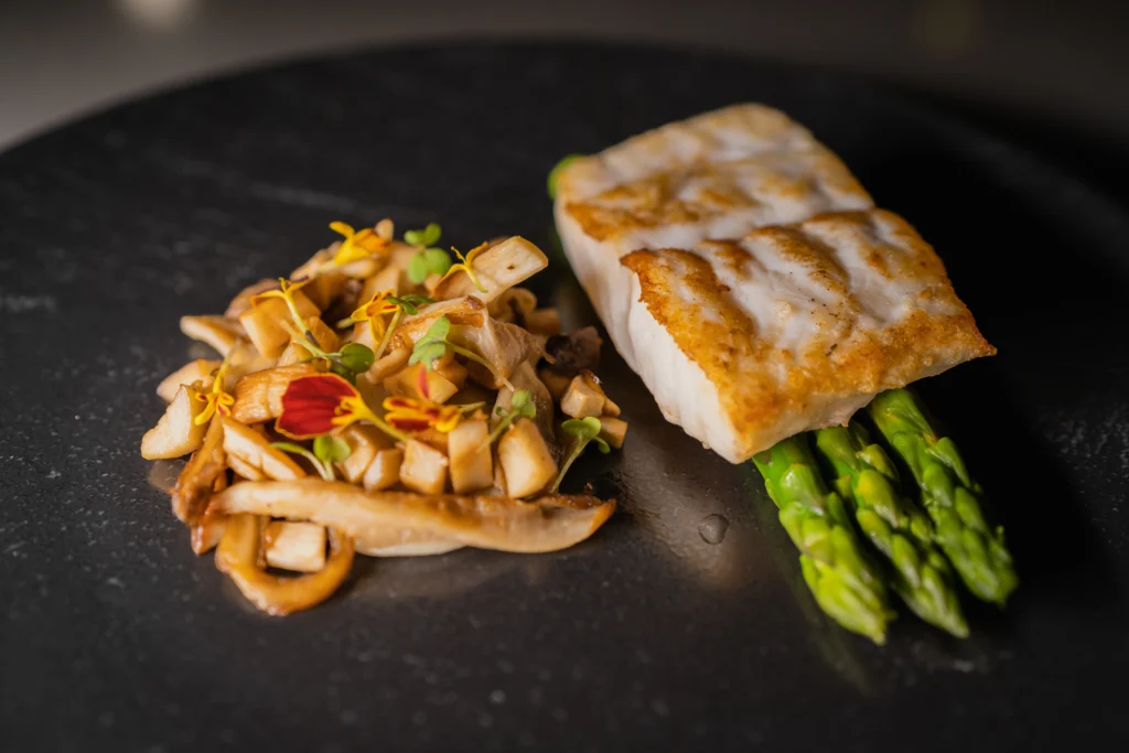 Grilled swordfish steak with lemon, garlic, and olive oil on a plate