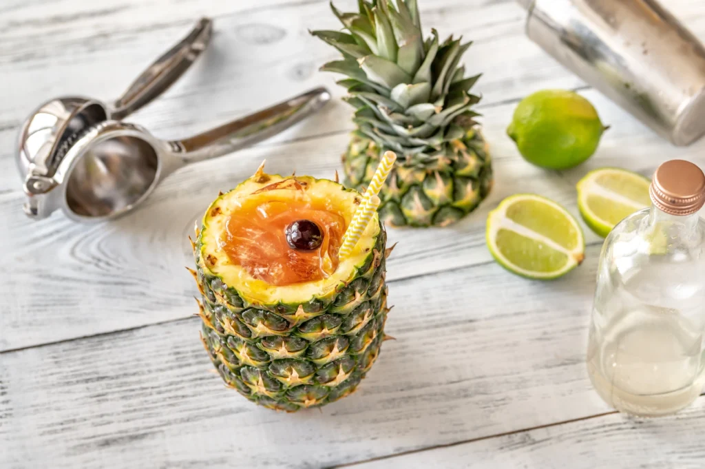 A refreshing pineapple margarita served in a salt-rimmed glass with a lime wedge and pineapple slice garnish