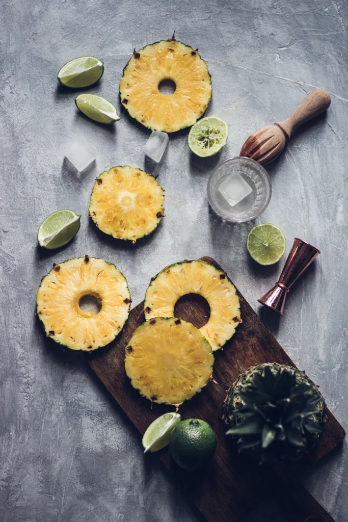 A refreshing pineapple margarita served in a salt-rimmed glass with a lime wedge and pineapple slice garnish