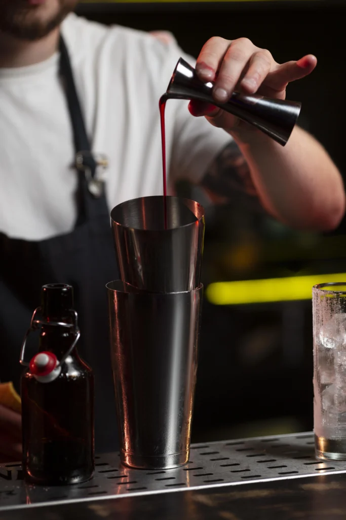 Classic Black Manhattan cocktail served in a coupe glass with an orange twist garnish