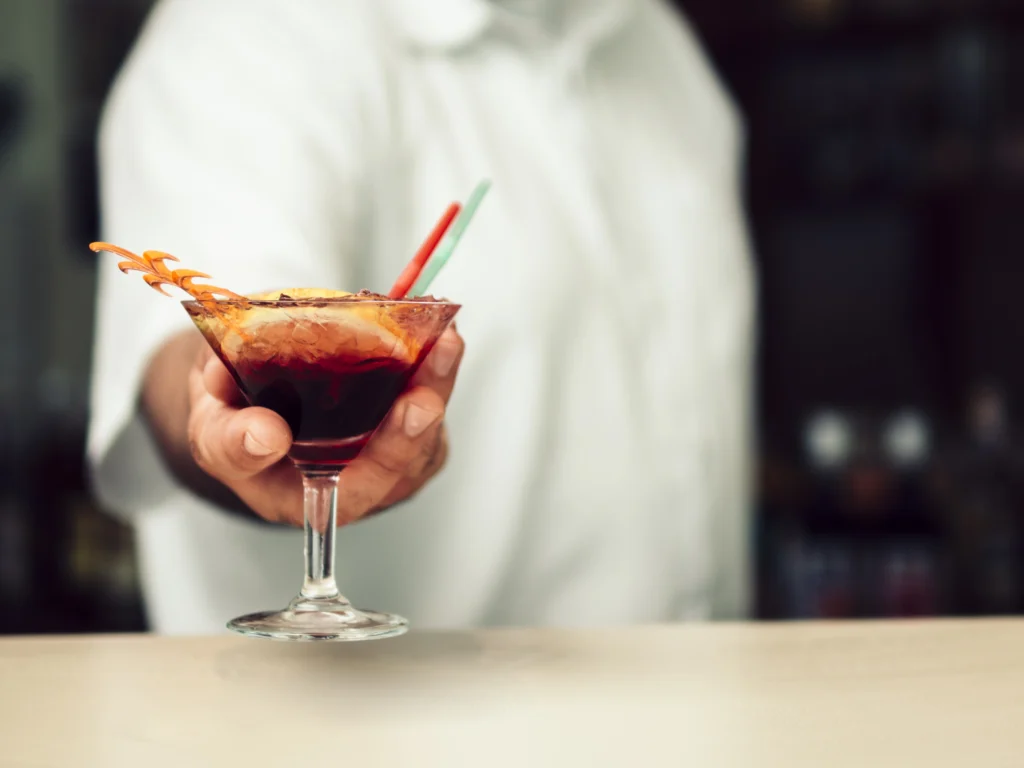 Classic Black Manhattan cocktail served in a coupe glass with an orange twist garnish