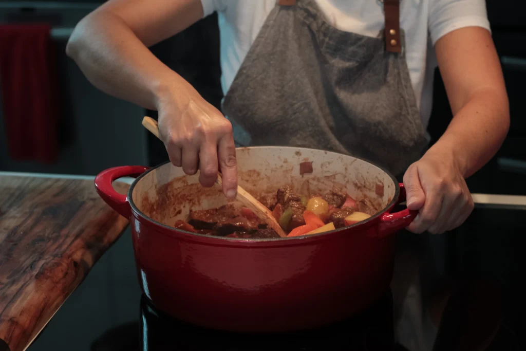 A delicious crock pot meal with ground beef, vegetables, and spices simmering inside.