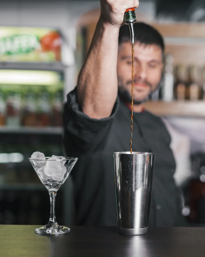 Classic Black Manhattan cocktail served in a coupe glass with an orange twist garnish