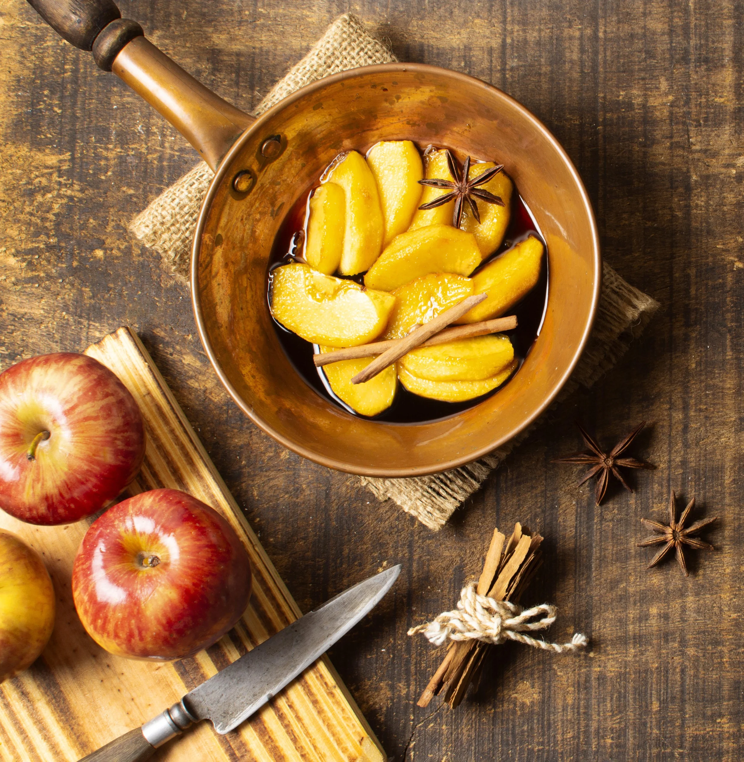 Caramelized apple slices cooking in a skillet with butter and cinnamon