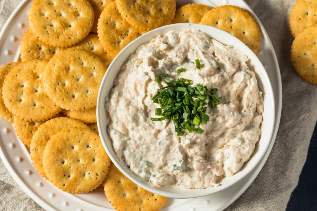 Creamy Boudin Dip served with crispy crackers and garnished with green onions
