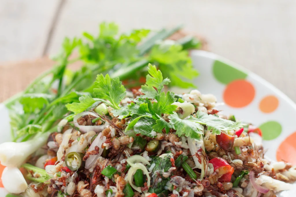 A delicious bowl of seasoned bush beans cooked with herbs and spices, garnished with fresh parsley.