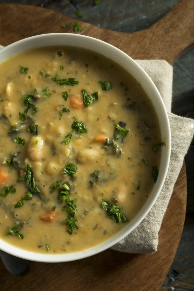 A delicious bowl of seasoned bush beans cooked with herbs and spices, garnished with fresh parsley.
