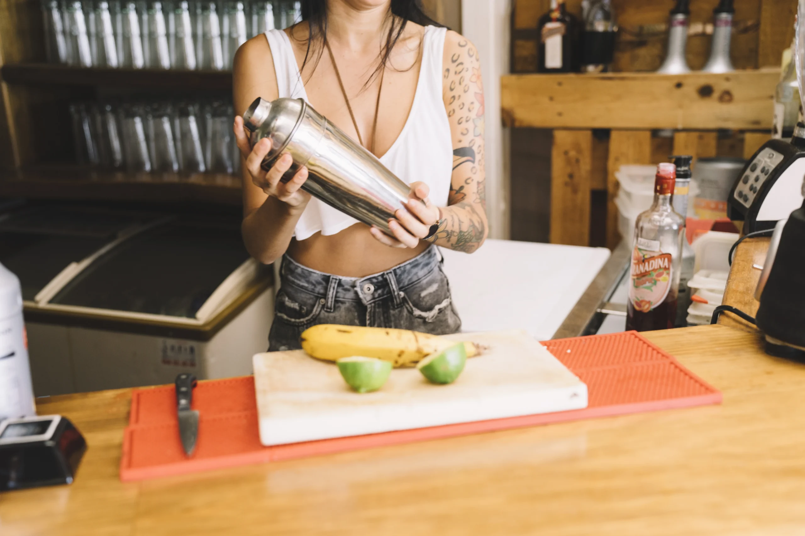 Iced banana coffee drink in a tall glass with a straw and banana slices garnish