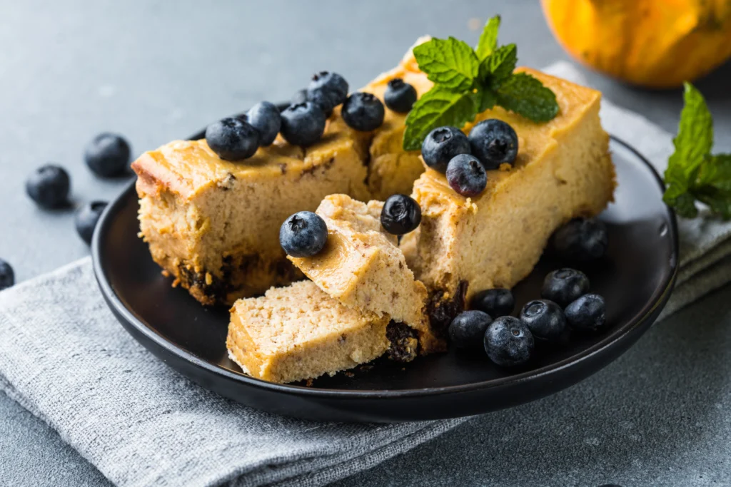 Low-calorie protein cheesecake slice on a plate with a fork