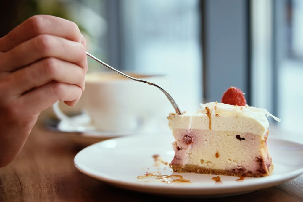 Low-calorie protein cheesecake slice on a plate with a fork