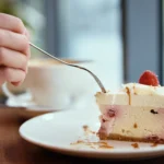 Low-calorie protein cheesecake slice on a plate with a fork