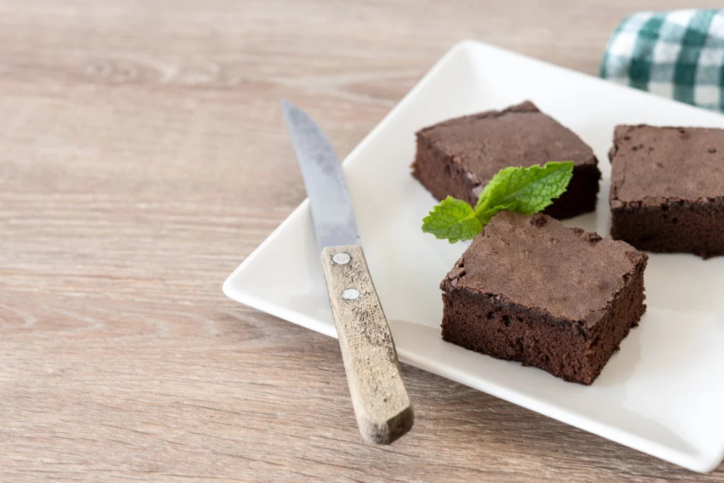 Freshly baked weed brownies on a plate with a rich chocolate topping