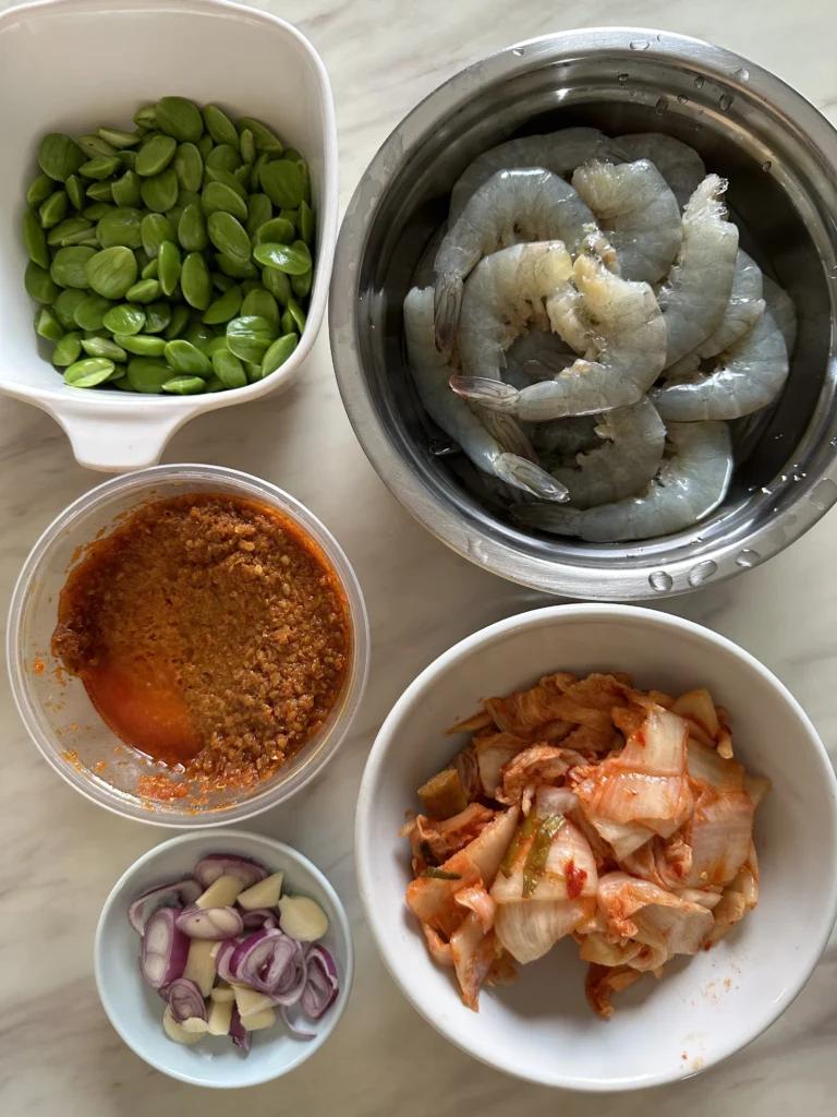 Bang Bang Shrimp
Crispy, golden-brown shrimp coated in a creamy orange sauce, garnished with finely chopped green onions, in a white bowl with an air fryer visible in the background