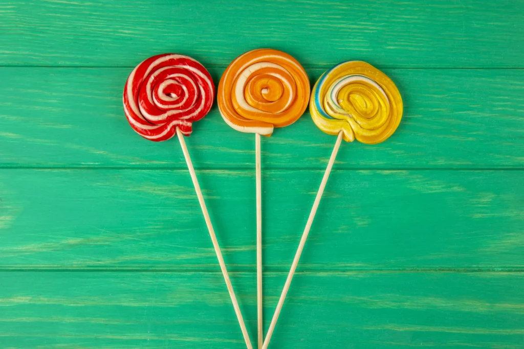 Colorful homemade lollipops on a wooden table, perfect for a sweet treat