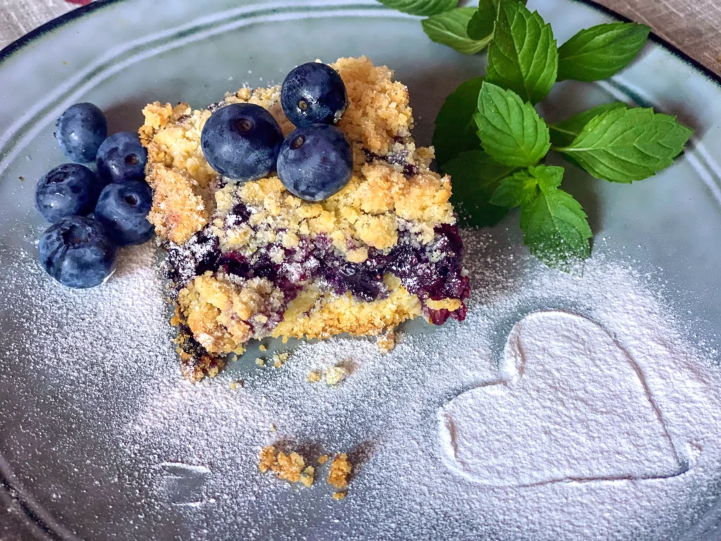 Freshly baked homemade blueberry rustic crumble with oats, served warm in a baking dish