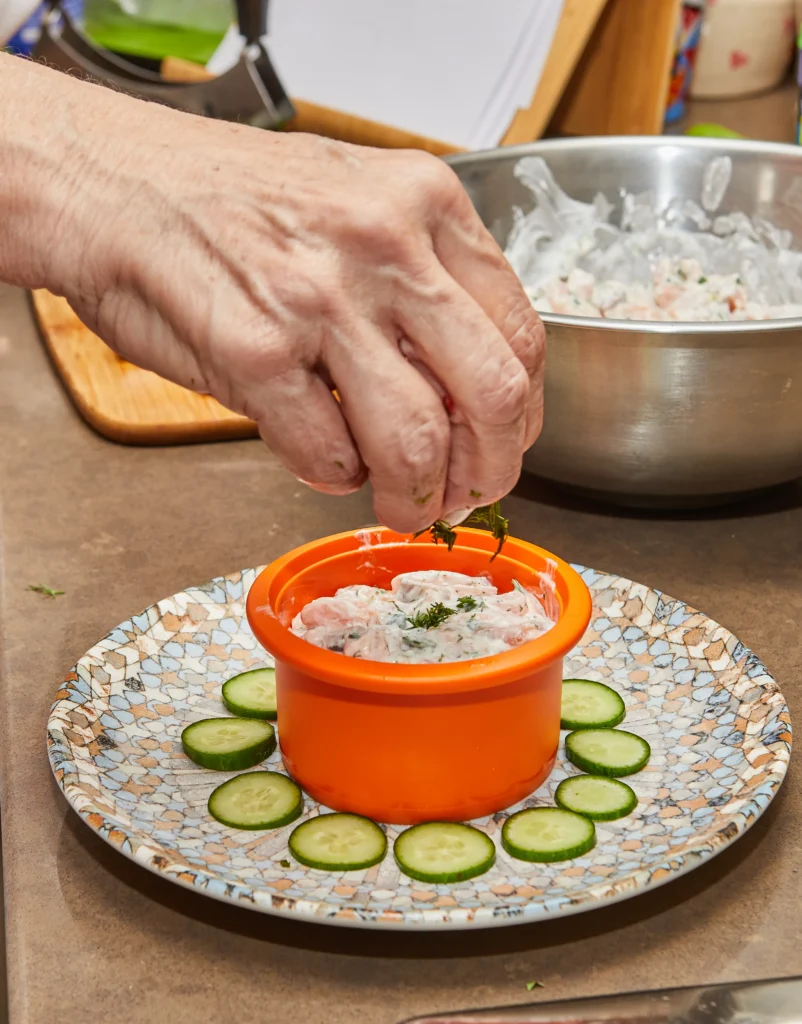 Ultimate Boat Dip served with tortilla chips, garnished with bacon, jalapeños, and green onions.
