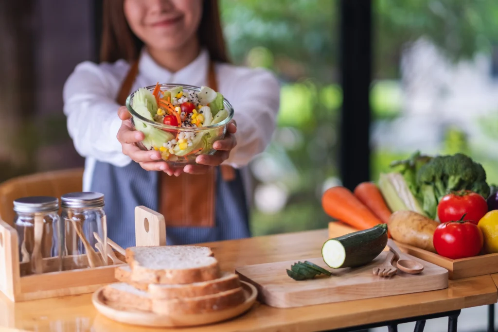 Authentic 1905 Salad with crisp lettuce, Swiss cheese, ham, olives, and homemade dressing served in a rustic bowl