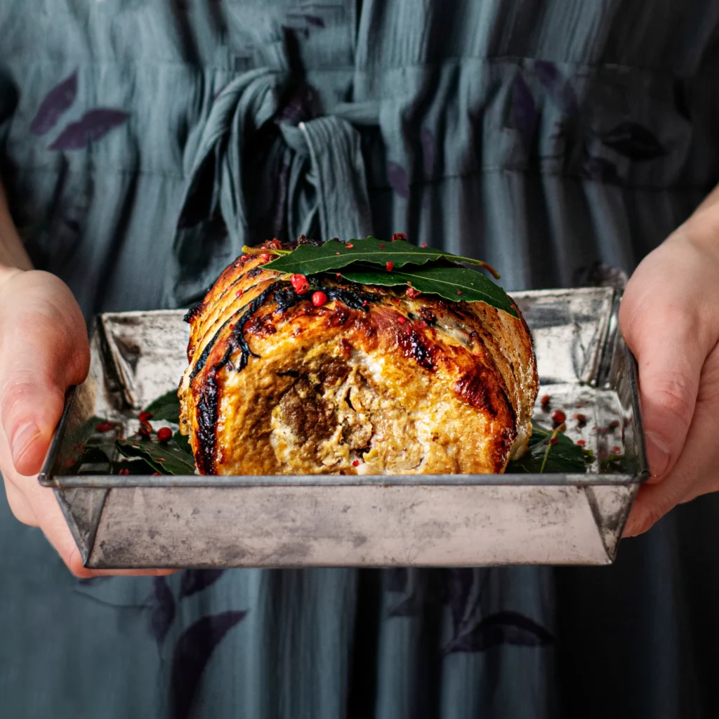 Smoked turkey breast on a platter garnished with fresh herbs, perfect for a holiday meal