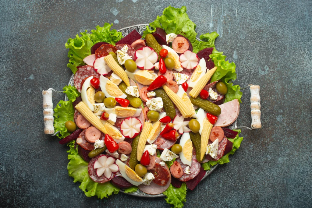 Authentic 1905 Salad with crisp lettuce, Swiss cheese, ham, olives, and homemade dressing served in a rustic bowl