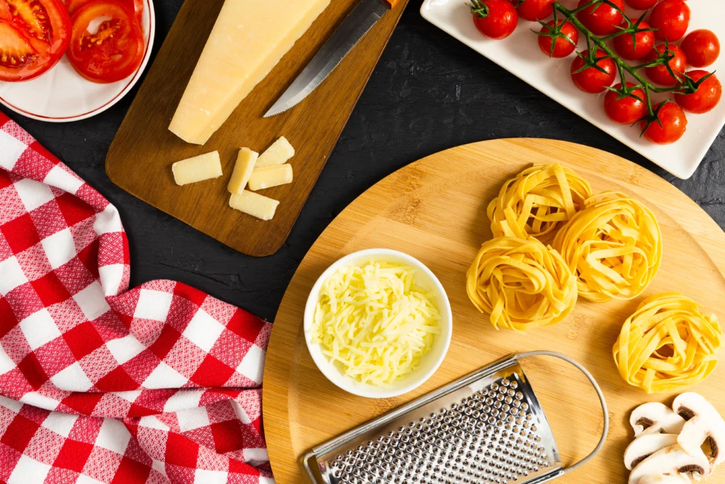 A bowl of creamy Boursin cheese pasta topped with fresh herbs and served in a white dish.