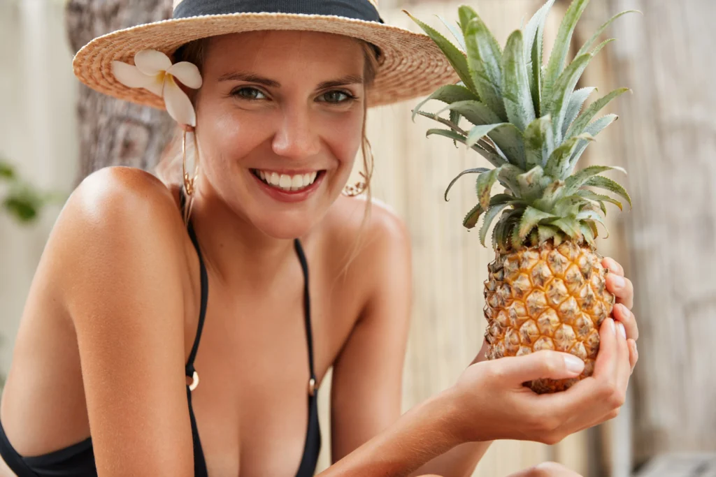 A refreshing pineapple margarita served in a salt-rimmed glass with fresh pineapple slices and a lime wedge.