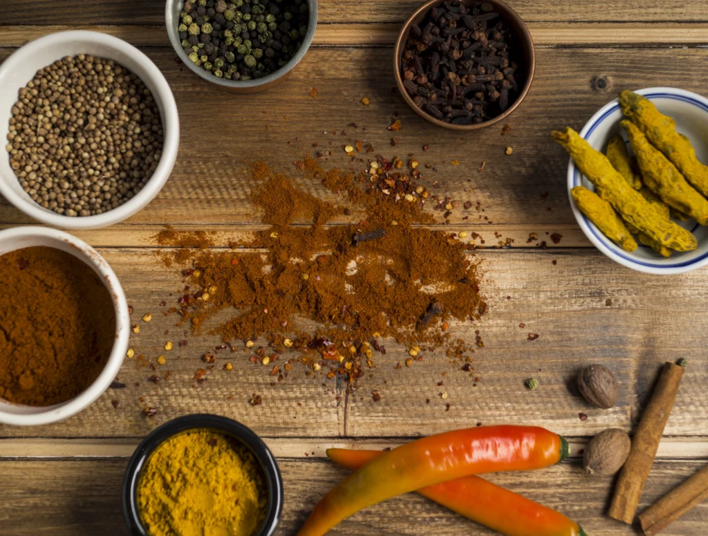Bowl of homemade fajita seasoning blend surrounded by fresh spices, ready for tacos, chicken, or vegetables