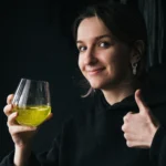 Refreshing homemade limoncello in a glass bottle with fresh lemons