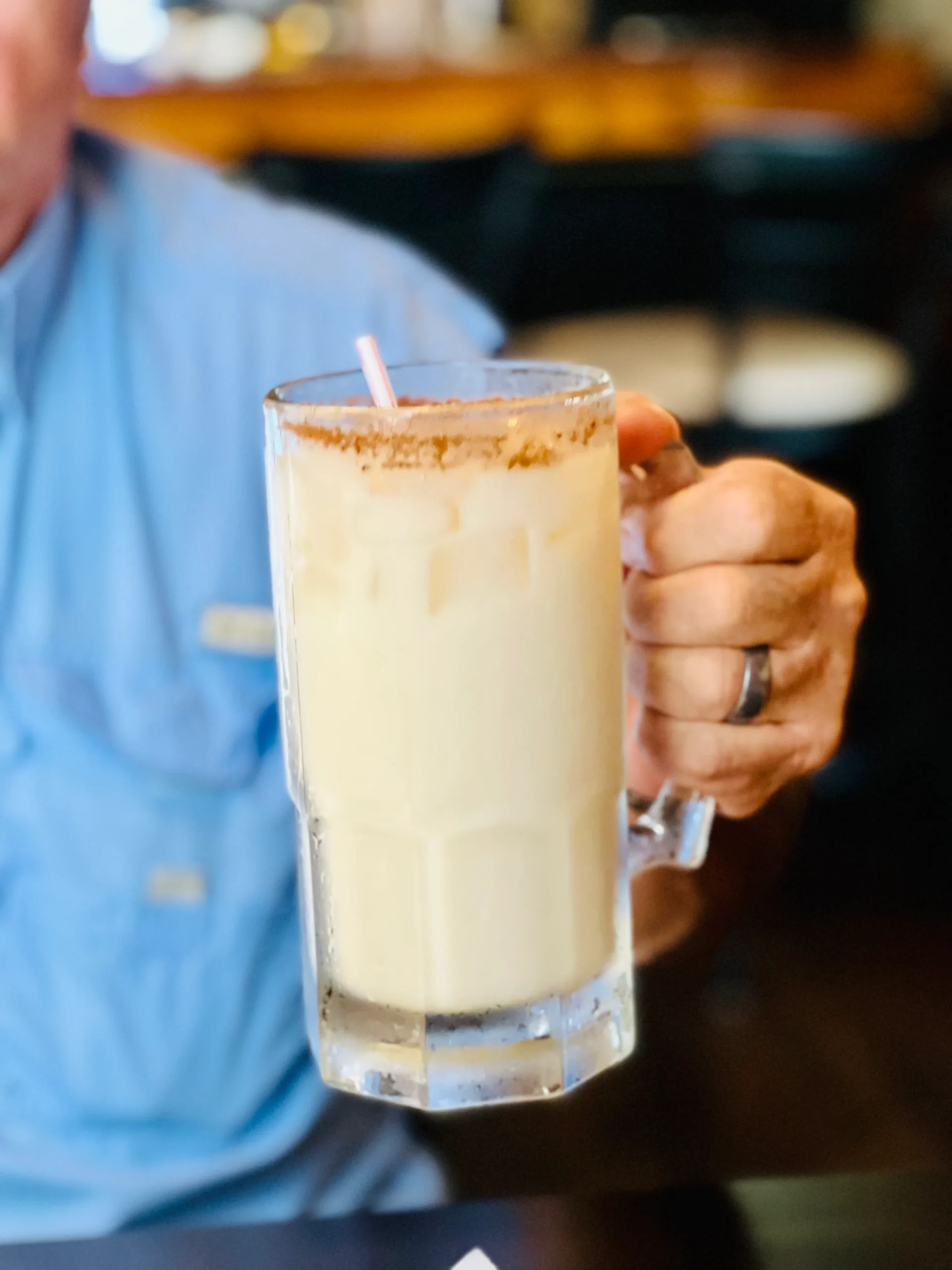 A frothy glass of homemade magical Butterbeer topped with whipped cream and caramel drizzle, inspired by the Harry Potter series.