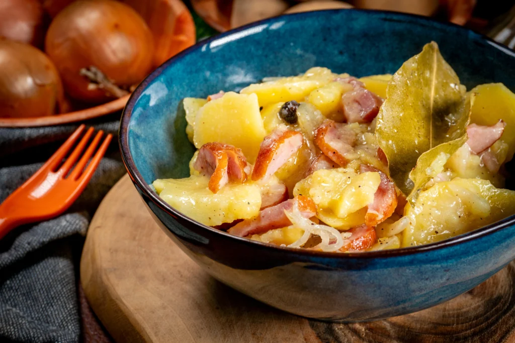 Warm German potato salad with bacon, onions, and fresh parsley in Grandma’s traditional recipe style