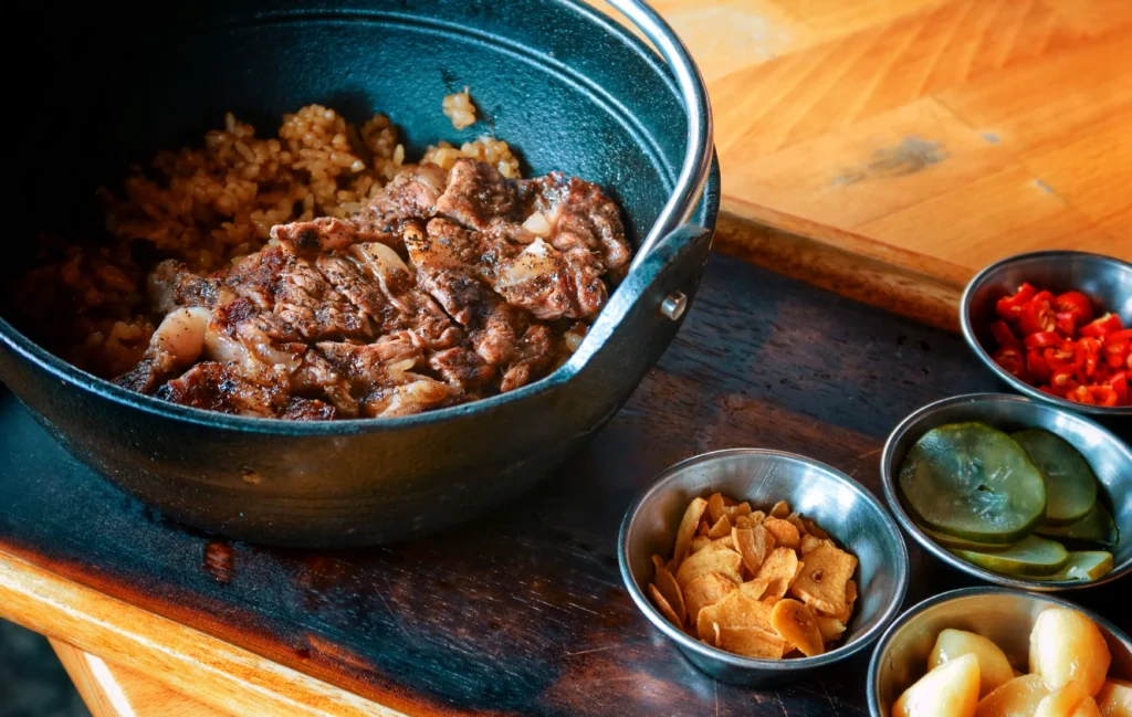 Easy Korean Beef Recipe served with rice and green onions.