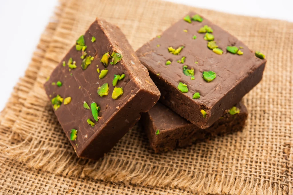 Fantasy Fudge Recipe
Fantasy Fudge Recipe
Quick and Magical Fantasy Fudge squares topped with walnuts on a wooden board.