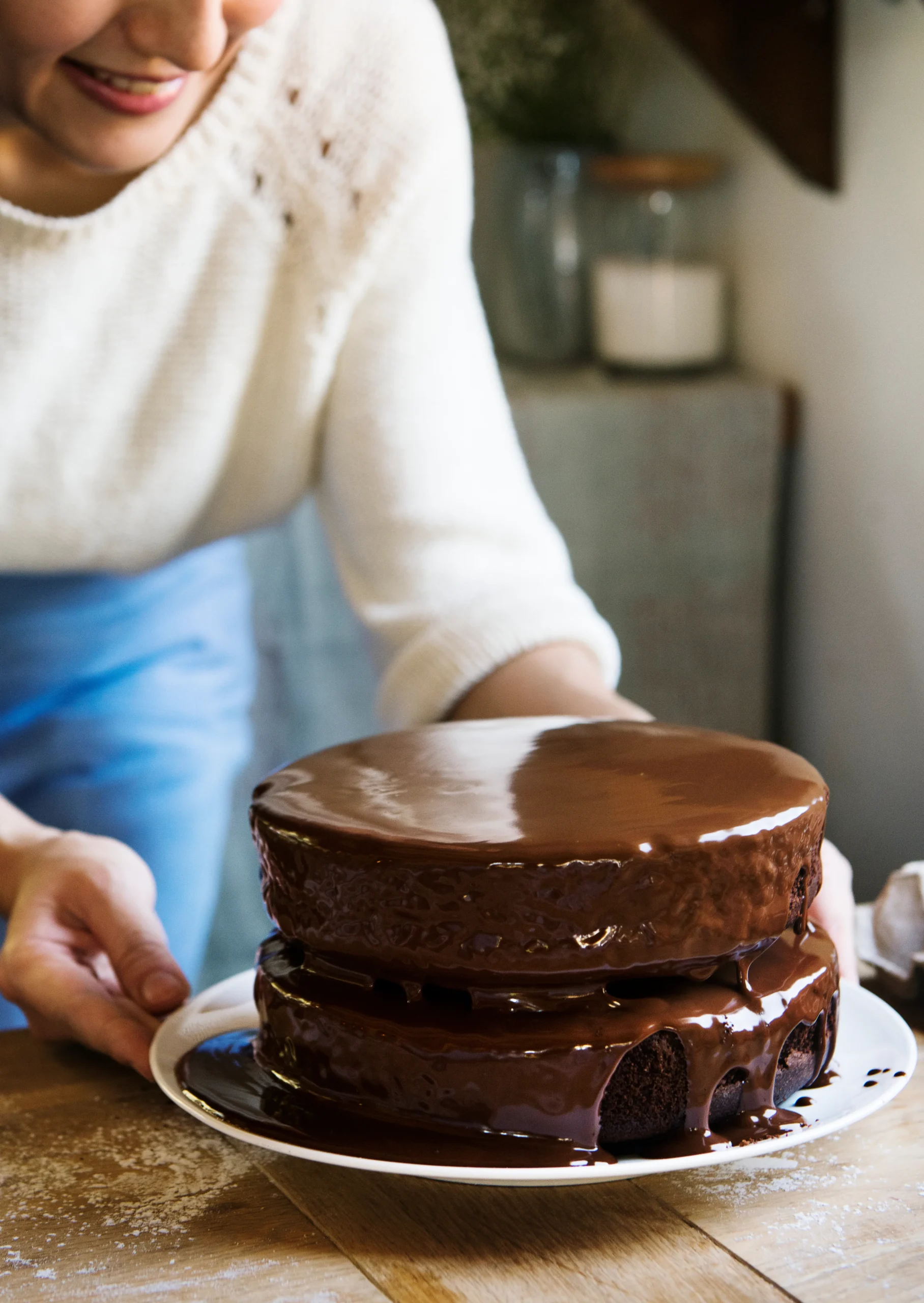 Homemade chocolate ganache being poured over a cake, made with rich dark chocolate and cream