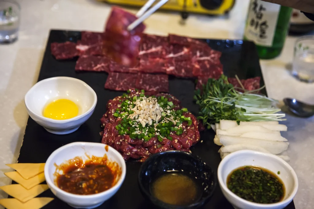 Easy Korean Beef Recipe served with rice and green onions.