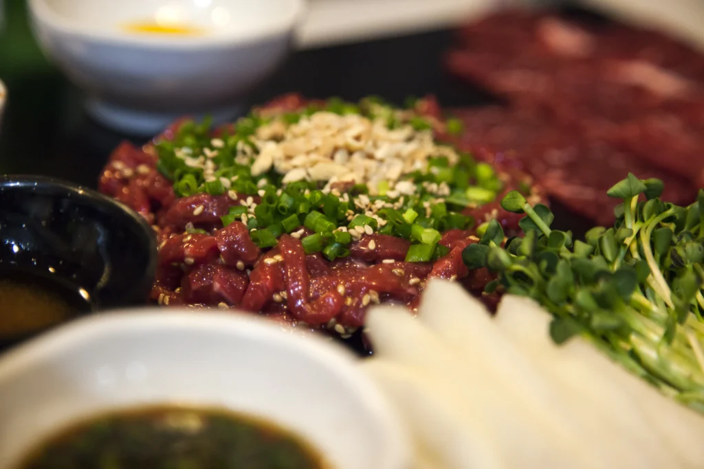 Easy Korean Beef Recipe served with rice and green onions.