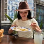 Creamy corn dip served in a bowl with tortilla chips on the side.