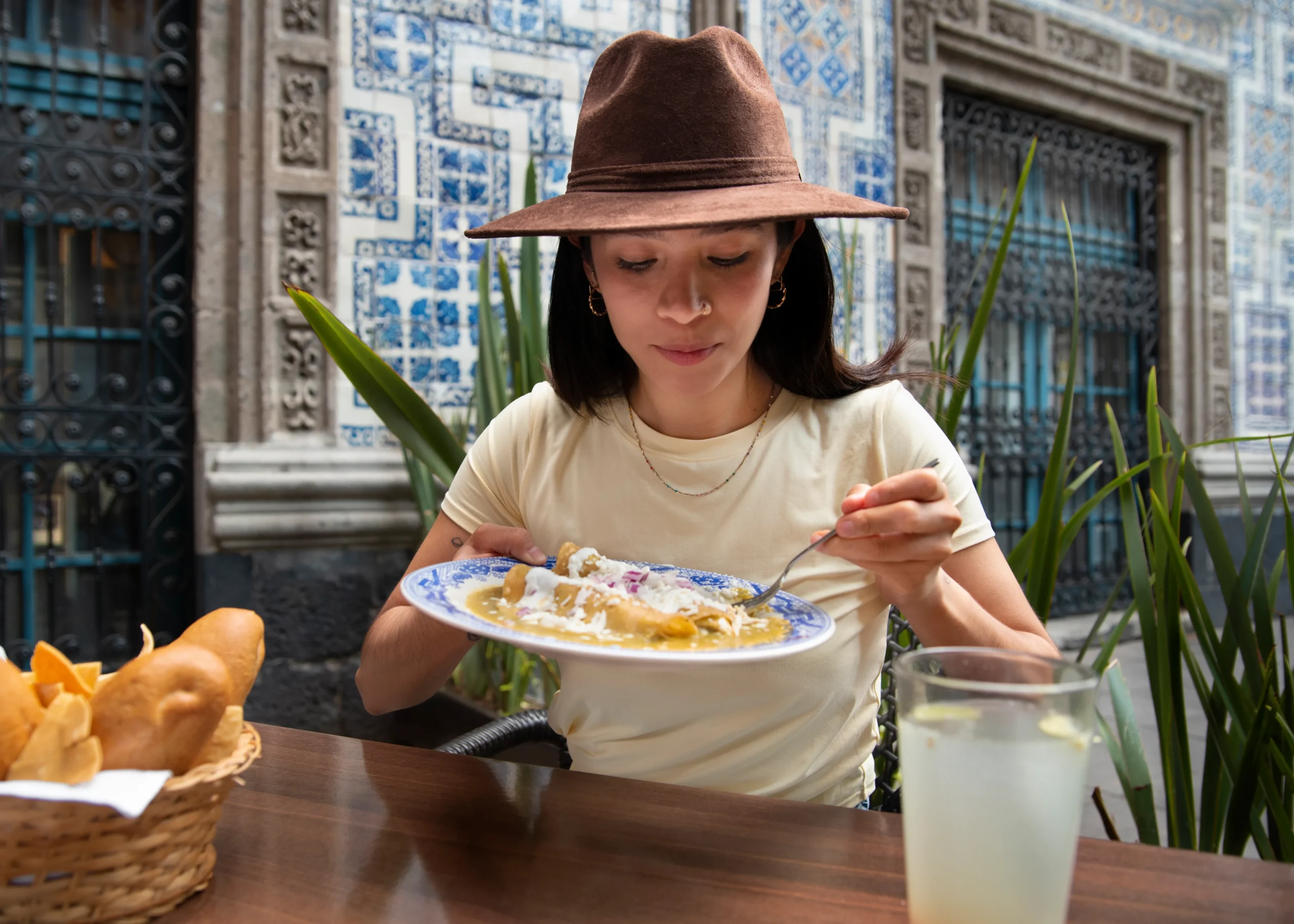 Creamy corn dip served in a bowl with tortilla chips on the side.