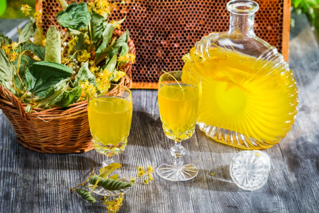Refreshing homemade limoncello in a glass bottle with fresh lemons