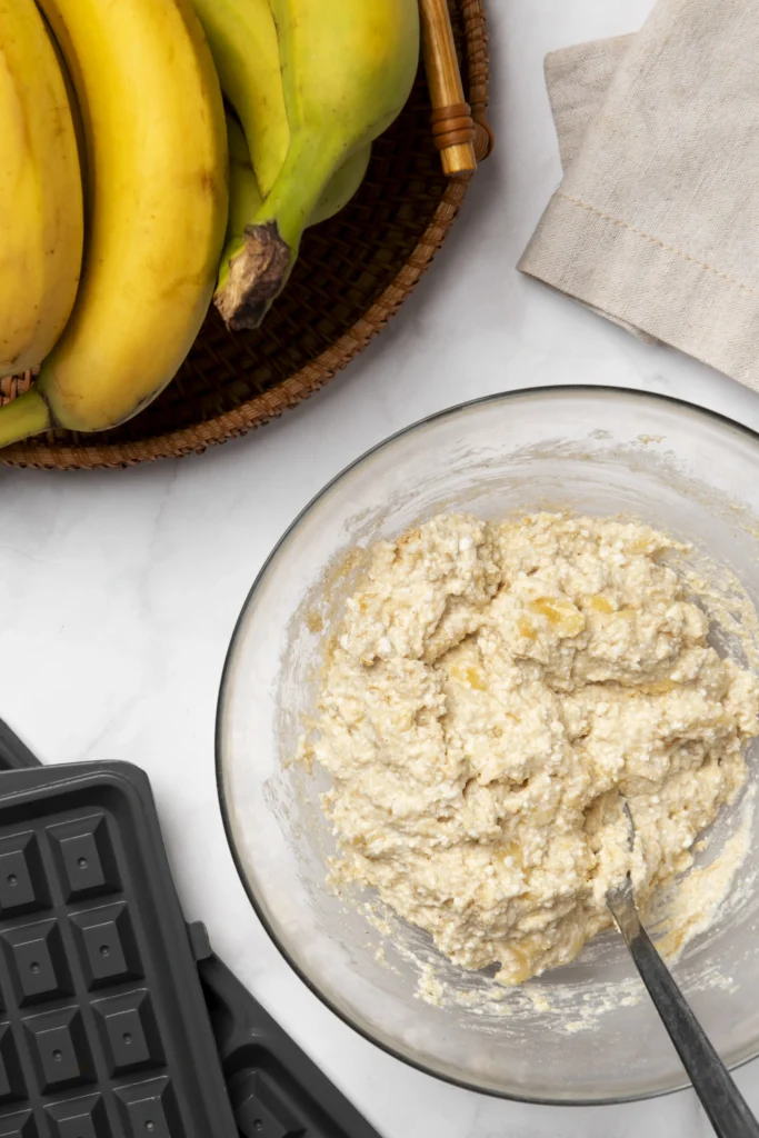 Freshly baked chocolate chip banana bread topped with toasted walnut crunch on a wooden cutting board