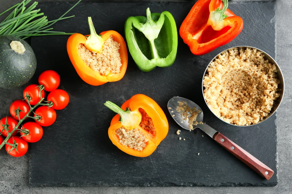 Avocado  & quinoa stuffed bell peppers on a plate, healthy colorful lunch