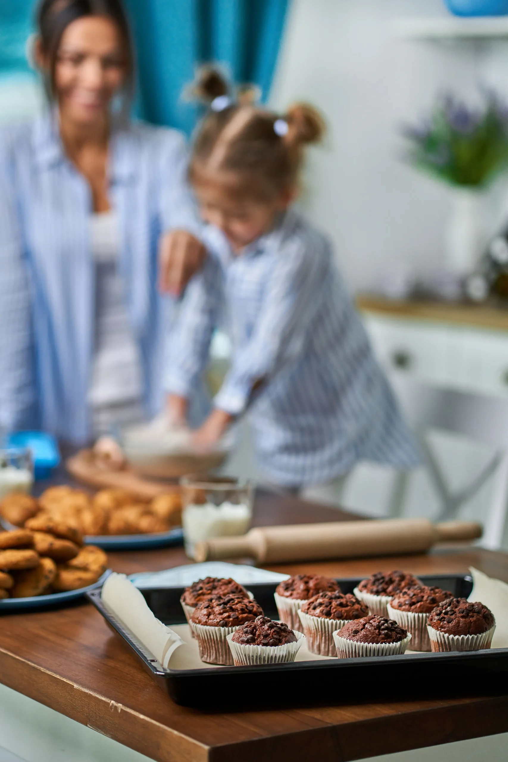 Chocolate muffins with colorful Olympic-themed sprinkles on top, perfect for kids.