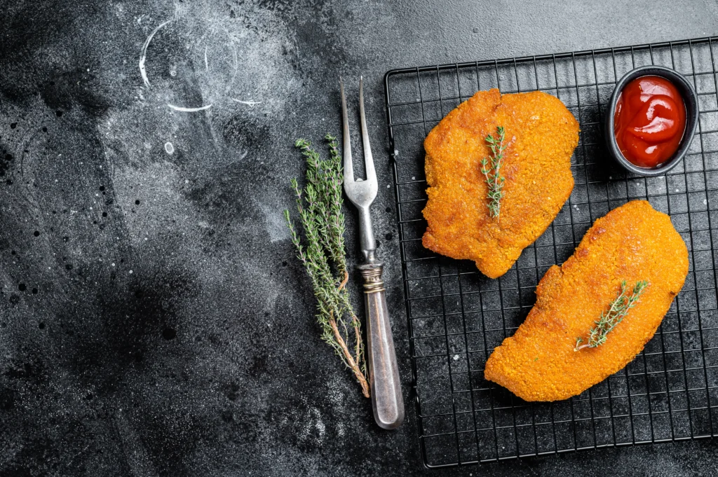 Schnitzel Recipe
Crispy air fryer schnitzel served with lemon wedges and fresh parsley on a plate.