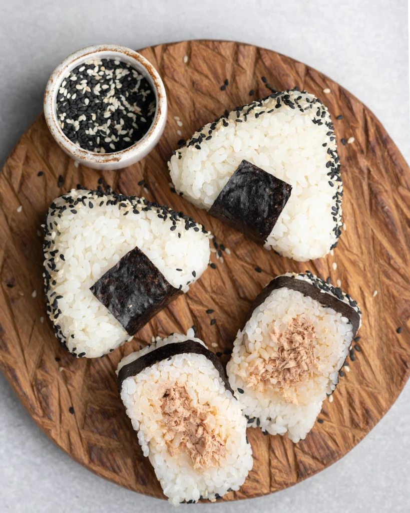 Traditional Japanese onigiri rice balls wrapped in seaweed, ready to eat.