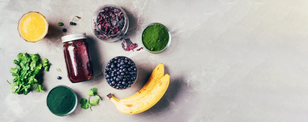 Energizing spirulina and berry smoothie in a glass topped with fresh berries, a healthy green breakfast drink