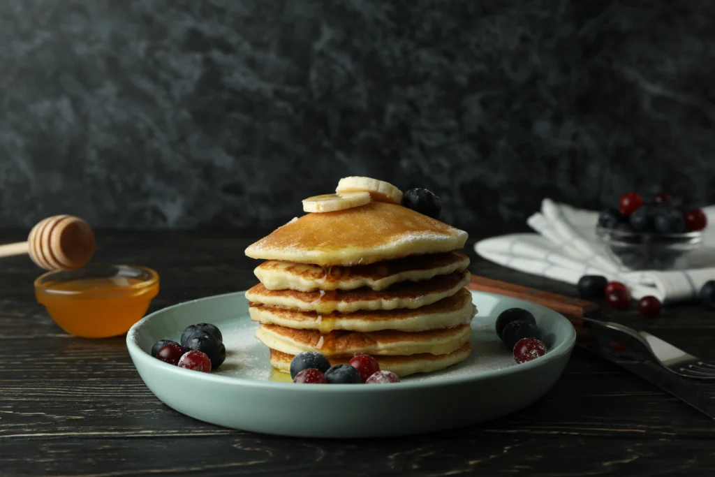 Healthy gluten-free pancakes made with natural ingredients, topped with fresh berries and maple syrup