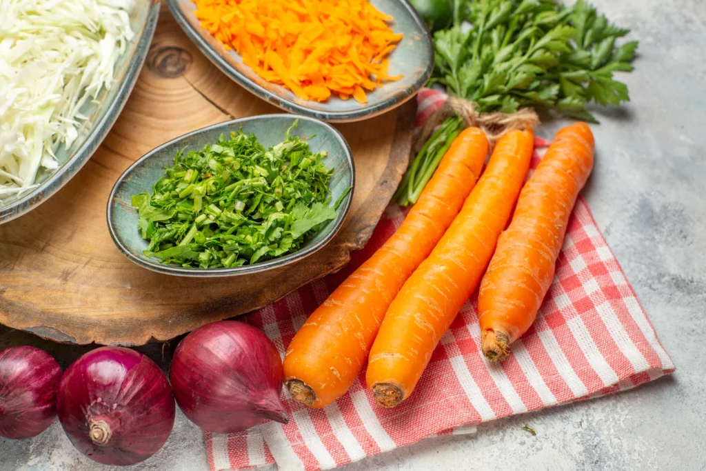 Moroccan Carrot & Orange Salad made with fresh carrots, juicy orange slices, olive oil, and Moroccan spices served in a rustic bowl