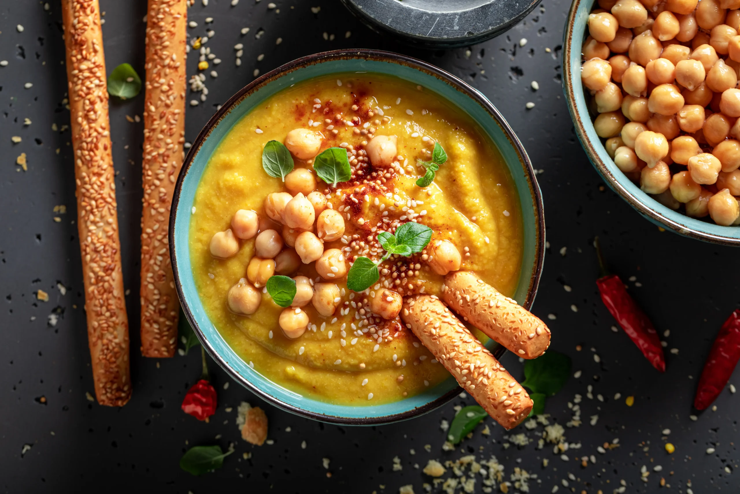 Creamy butternut squash and chickpea soup served in a bowl, garnished with fresh herbs.
