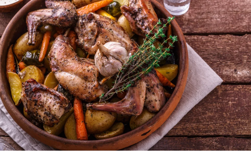 Herb-roasted chicken served with colorful seasonal vegetables on a rustic plate