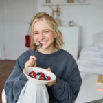 Colorful berry smoothie bowl topped with homemade granola, fresh berries, and a drizzle of honey